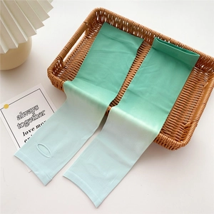Detail of gradient green ice silk cooling sleeves with thumb holes in a basket