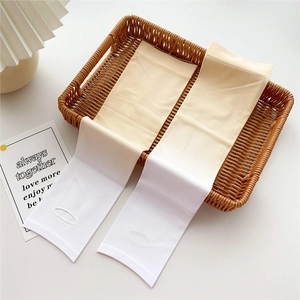 Detail view of ice silk cooling arm sleeves with thumb holes on a wicker basket