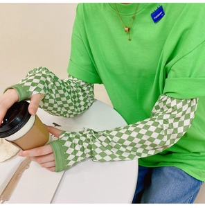 Close-up of grass green short sleeve shirt layered with checkered ice silk sun sleeves