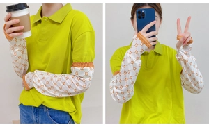 Detail view of white sun protection sleeves with orange elastic cuffs and geometric patterns