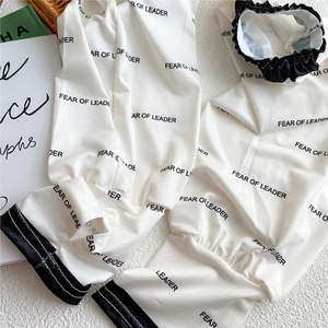 Detail of breathable ice silk sun sleeves with black FEAR OF LEADER letter print