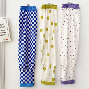 Detailed view of elastic cuffs on checkered and floral pattern sun protection sleeves