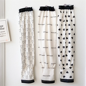 Detailed view of three protective sun sleeves with bear, heart, and letter patterns