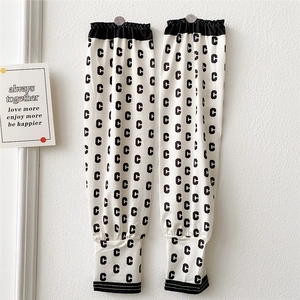Detail of white cooling arm sleeves with black letter C pattern and elastic cuffs