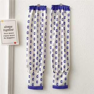Detailed view of cooling sun sleeves with blue C-pattern and elastic cuffs for sports