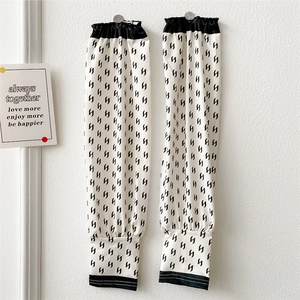 Close-up of summer cooling sun protection sleeves with stylish black S-pattern print