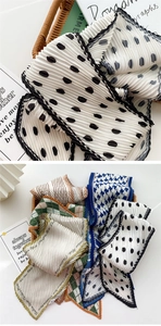 Macro shot of accordion pleated silk scarves with polka dots and houndstooth patterns