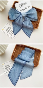 Detail of Morandi blue pleated long scarf with elegant wave edges and script patterns