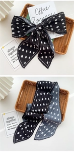 Detail of pleated polka dot silk scarf with elegant bow knot and crinkle texture