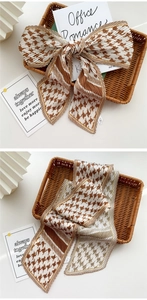 Detail of pleated silk scarf with brown houndstooth pattern and elegant bow knot style