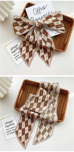 Detailed view of coffee-white pleated scarf with elegant diamond pattern texture