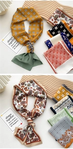 Flat lay of silk scarves with bohemian paisley and floral patterns on a wooden tray
