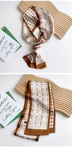 Detail of skinny scarf with vintage floral and houndstooth patterns in brown and beige