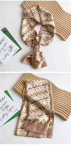 Macro shot of long silk scarf with vintage geometric patterns and silky satin texture