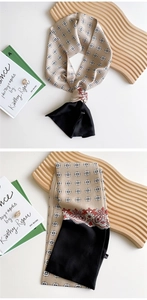 Detail of silk-style skinny scarf featuring paisley patterns and champagne geometric motifs