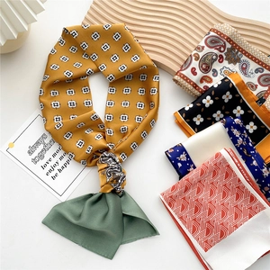 Stylish assorted long silk scarves with geometric and floral patterns in elegant stack