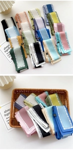 Macro shot of assorted thin satin hair ribbons in various colors with stripe accents