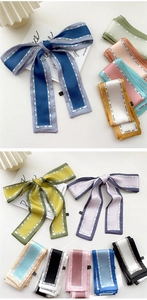 Detail view of colorful satin skinny scarves with elegant beautiful girl letter prints