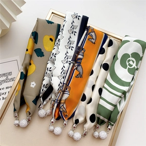 Five silk neck scarves with pearl pendants in floral and horse patterns