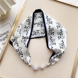 Detail of floral silk scarf necklace with crystal-encrusted sphere pendants and silver hardware