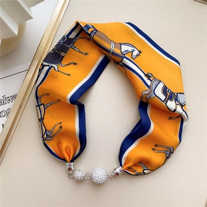 Detail of equestrian print silk scarf necklace with sparkling silver metal ball buckle