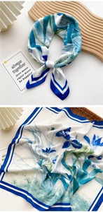 Detail of silk scarf with blue iris floral print and elegant striped border design