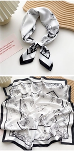 Detail of silk scarf with floral butterfly prints and elegant black border finish