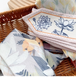 Detail of floral printed silk neckerchiefs elegantly layered in a woven basket