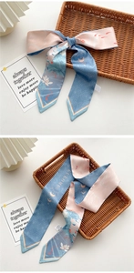 Detailed close-up of double-sided silk ribbon with floral lotus and koi fish patterns