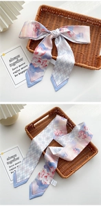 Narrow silk scarf with pink lotus and grey rhombus pattern tied as a hair ribbon