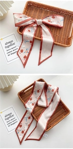 Detail of floral skinny silk scarf with tulip pattern in pink and orange bow style