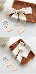 Close-up of yellow tulip and rhombic floral skinny scarf tied in a bow