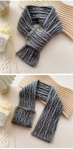 Detail of grey cable-knit winter scarf with decorative wooden buttons and wool texture