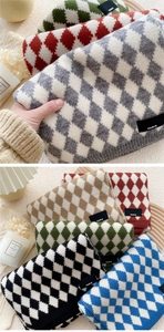 Detail showing the thick diamond pattern knit texture and Paris logo label on various scarves