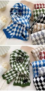 Detail of argyle knit scarf featuring thick dual-color weaving and a small logo patch