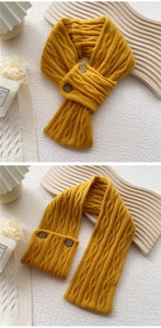 Detail of ginger yellow cable knit scarf featuring vintage brown button closure