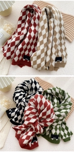 Detailed knit texture of diamond pattern scarves featuring a woven Paris brand tag
