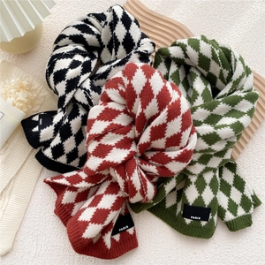 Diamond pattern knit scarf in black, red, and green with Paris woven label detail