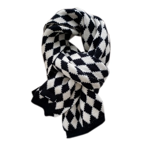 Classic black and white diamond pattern knit scarf with Paris tag on white background