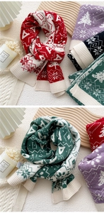 Detail of Christmas knitted scarf featuring festive snowflake and tree patterns