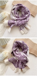Detail of purple and beige knitted scarf with snowflake jacquard and ribbed cuffs