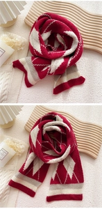 Close-up of red and white argyle knit scarf featuring soft wool texture and ribbed edges