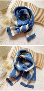 Close-up of blue and white diamond check knit scarf with warm winter lifestyle aesthetic