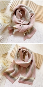 Close-up of pink and grey diamond lattice knit scarf with star jacquard patterns