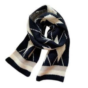Short diamond pattern knit scarf in black and white check with soft wool texture