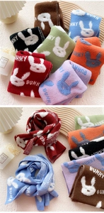 Detailed knit texture of colorful bunny winter scarves with soft plush material