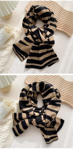Detailed close-up of thick knitted winter scarf with black and yellow stripes