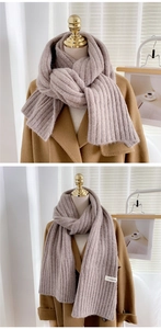 Gros plan d'une écharpe en tricot avoine avec texture côtelée et étiquette tissée