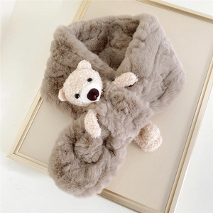 Detailed view of khaki plush faux fur scarf with a cute 3D white teddy bear ornament