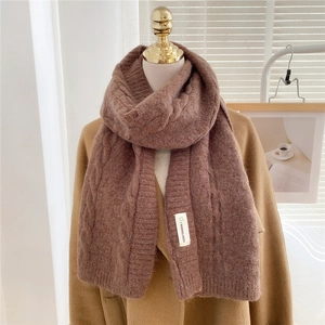 Brown cable knit scarf for women made of thick warm material shown on a mannequin